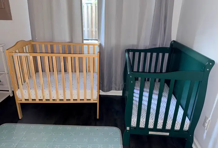 Little Roots infant care room with two prepared cribs