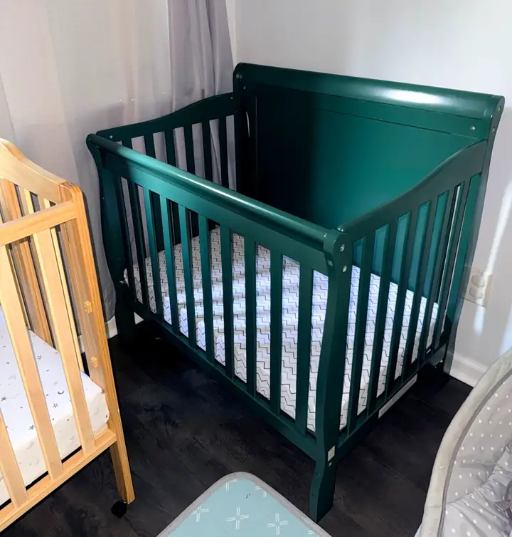 Green infant crib in the Little Roots care room